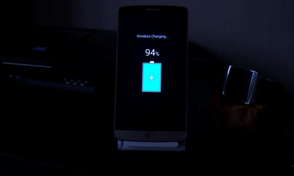 Overnight charging phone on nightstand with clock